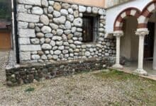 Muratura esterna in pietra a vista con giunti di malta e basamento
