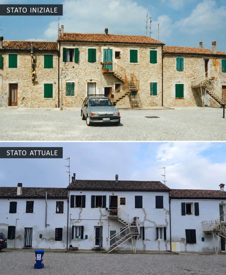 Facciata intonacata di edificio in pietra con distacchi sopra la fascia inferiore ripristinata Degrado degli intonaci su una muratura in pietra